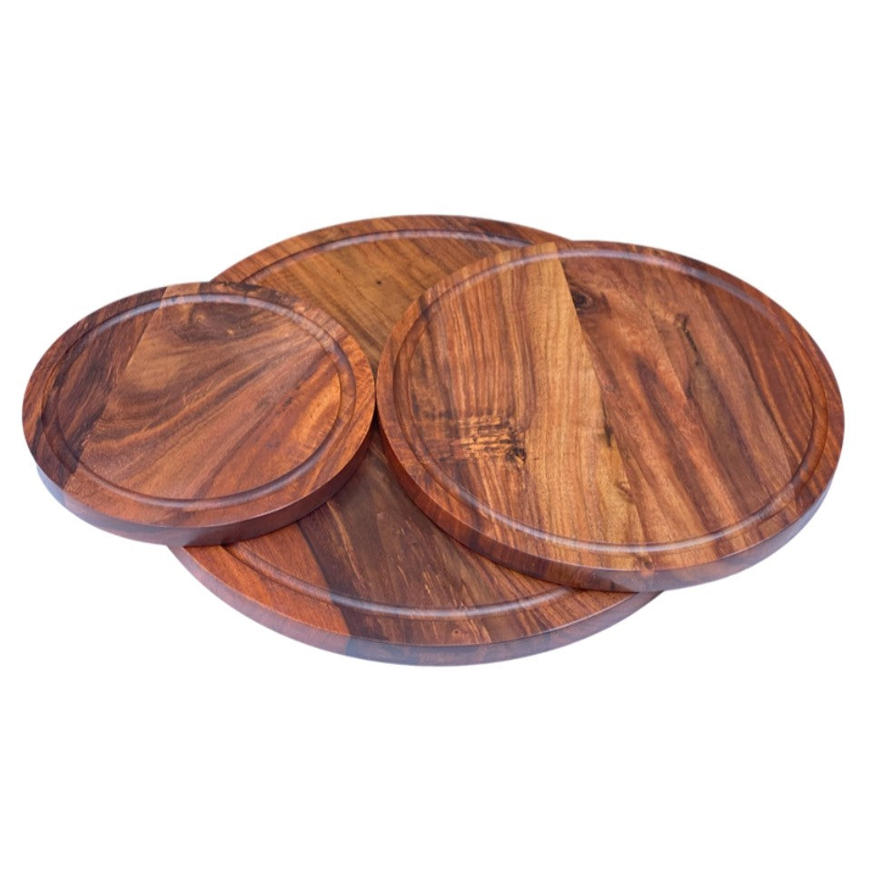 Set of three handcrafted round wooden platters made from premium acacia wood, featuring natural grain patterns and raised edges, perfect for serving pizza, charcuterie, and entertaining