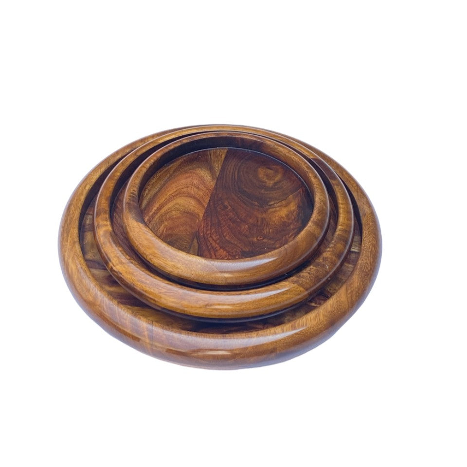 Handcrafted round wooden plate set with polished finish – nesting design.