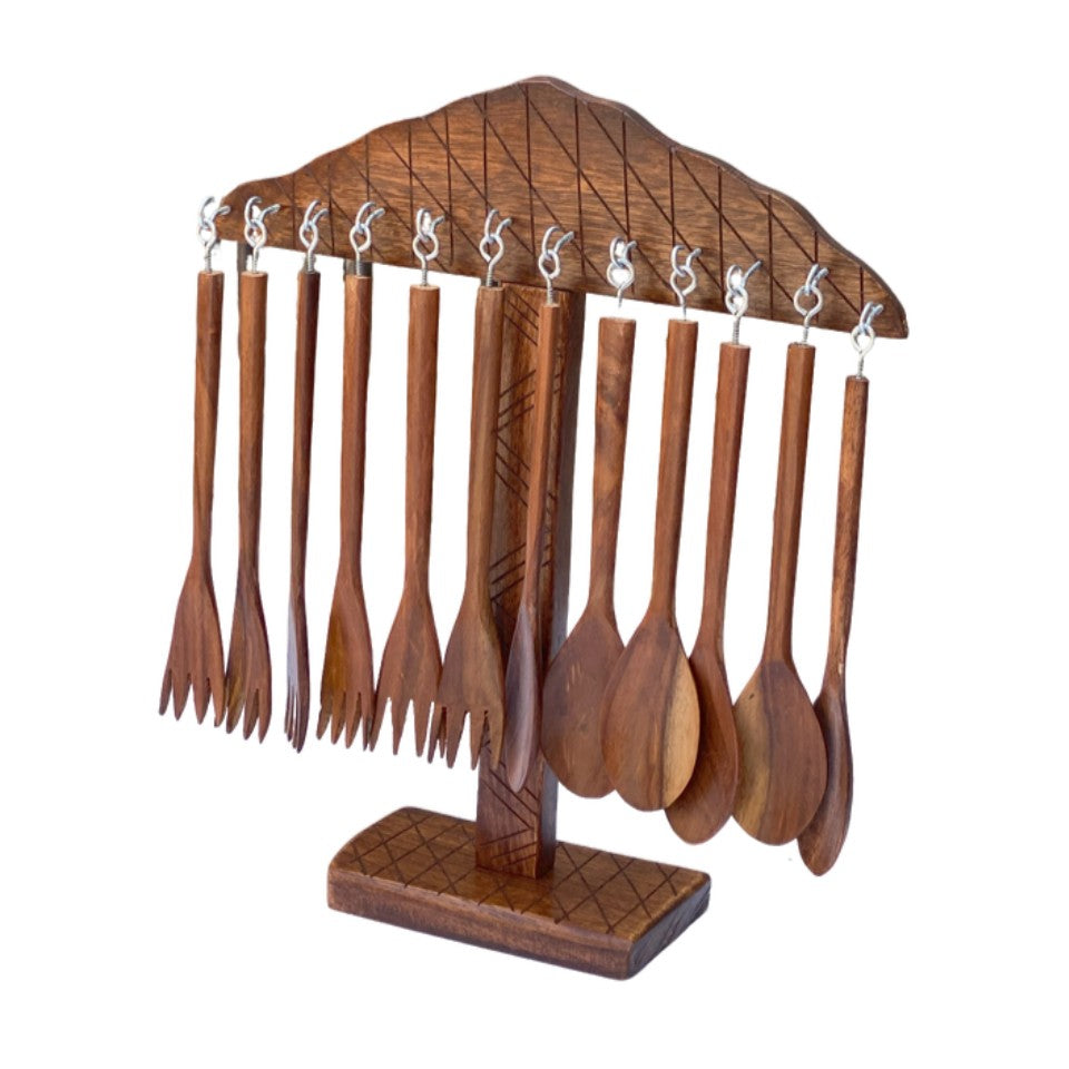 Wooden table spoons and forks hanging on carved wooden display stand - handcrafted cutlery set.