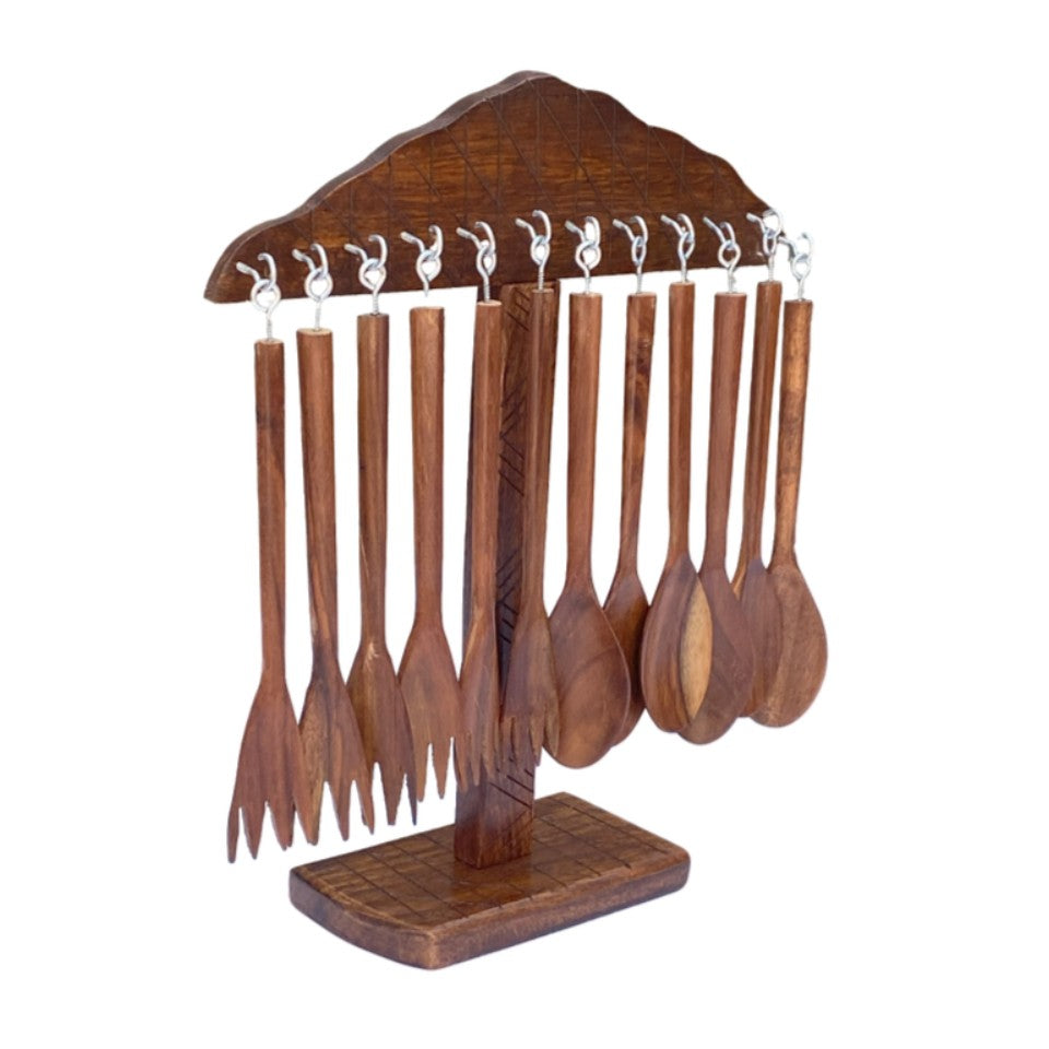 Wooden table spoons and forks hanging on carved wooden display stand - handcrafted cutlery set.