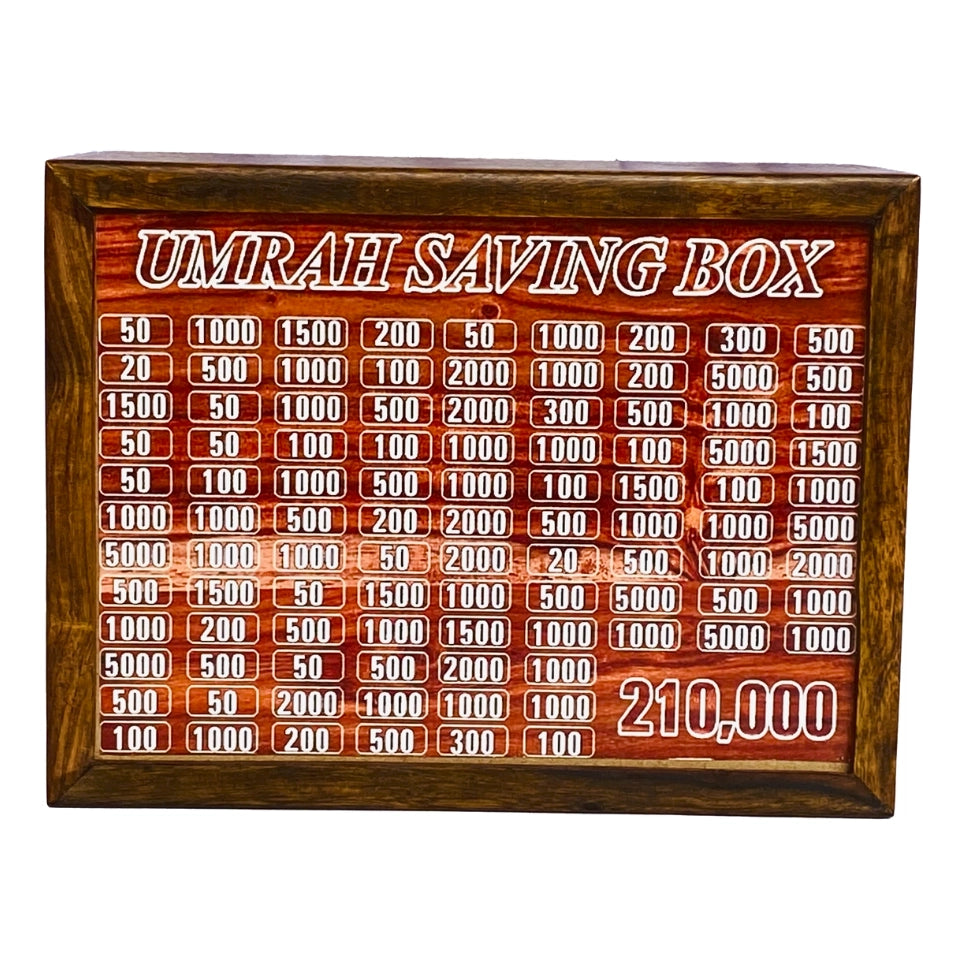 Wooden Umrah Saving Box with numbered compartments for Pakistani Rupee amounts on red background. Traditional Islamic savings method for pilgrimage fund with 210,000 PKR goal.