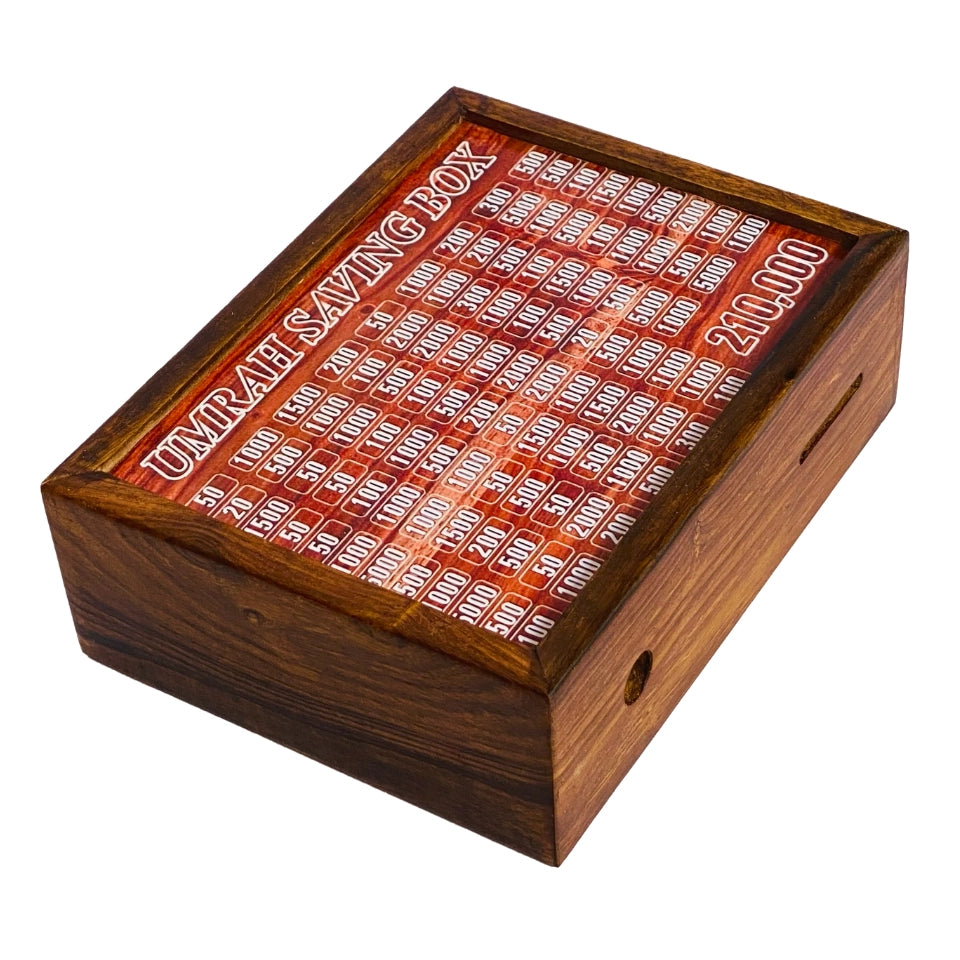 Wooden Umrah Saving Box with numbered compartments for Pakistani Rupee amounts on red background. Traditional Islamic savings method for pilgrimage fund with 210,000 PKR goal.