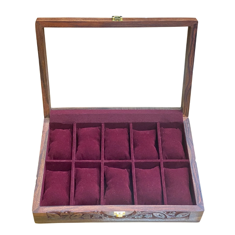 Handcrafted wooden watch box with glass lid open, showing burgundy velvet-lined compartments arranged in a grid pattern, featuring ornate carved details on the wooden frame